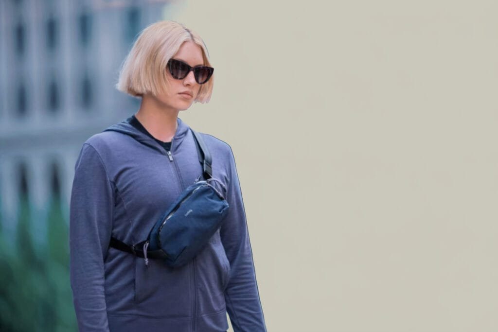 Best sling bag Bellroy Venture 2.5L shown worn crossbody by person with short blonde hair.