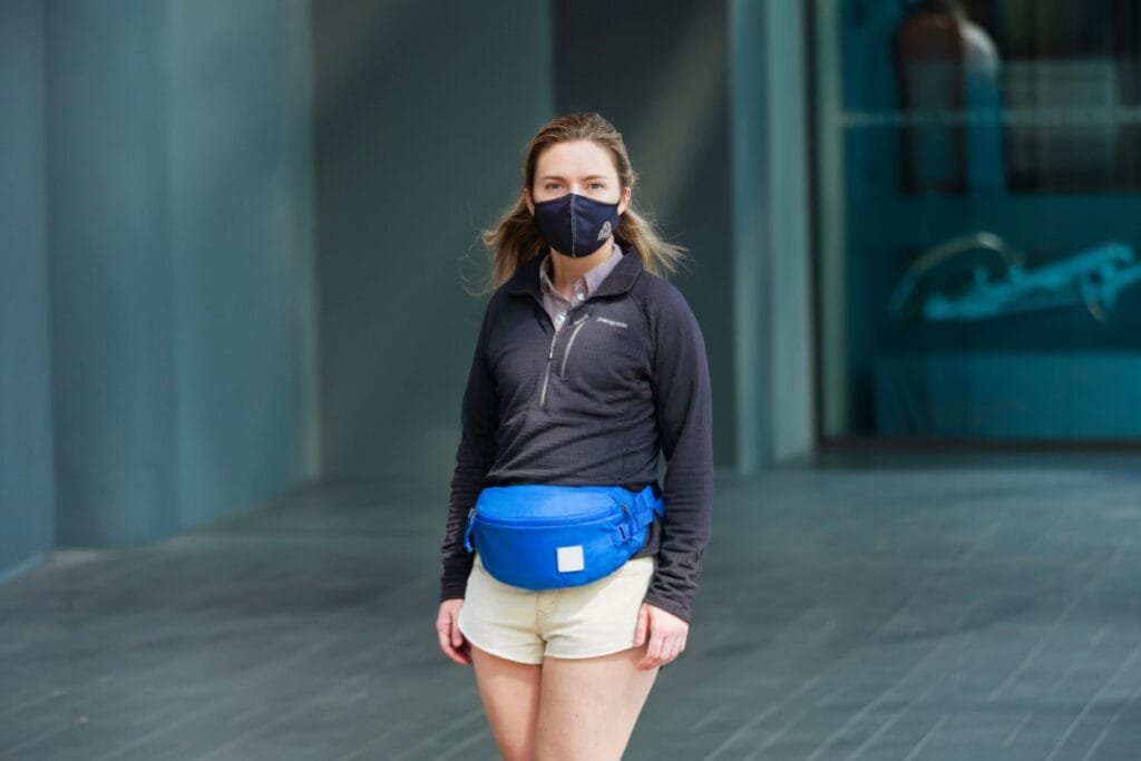 Best sling bag Evergoods Mountain Hip Pack 3.5L showcased on stylish woman in urban cityscape.