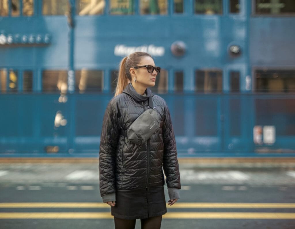 Best Sling Bag Heimplanet Transit Line Sling Pocket on city street with stylish woman and urban backdrop.