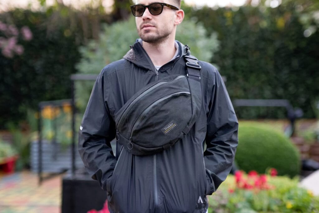 Best sling bag featuring Trakke Largo showcasing durable design and spacious compartments in park setting.
