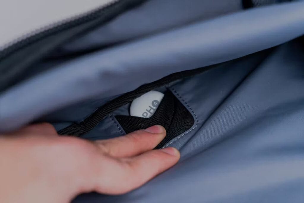 Best travel backpack showcasing Aer Travel Pack 3 with discreetly placed Airtag in sleek interior pocket.