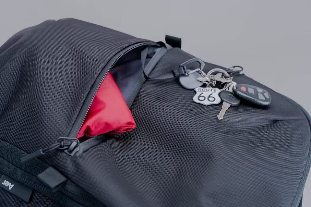 Best travel backpack Aer Travel Pack 3 close-up of pocket with keys and vibrant red lining.
