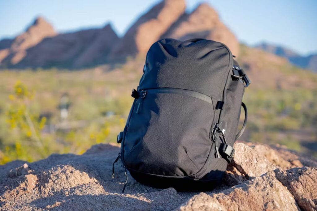 Best travel backpack Aer Travel Pack 3 in desert setting with striking rock formations.