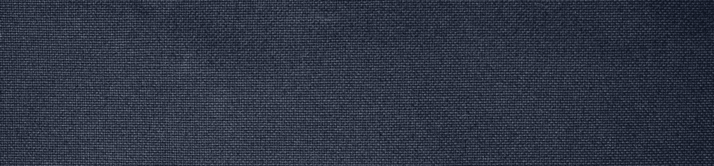 Best travel backpack featuring closeup of durable, indigo denim fabric with high-quality craftsmanship.