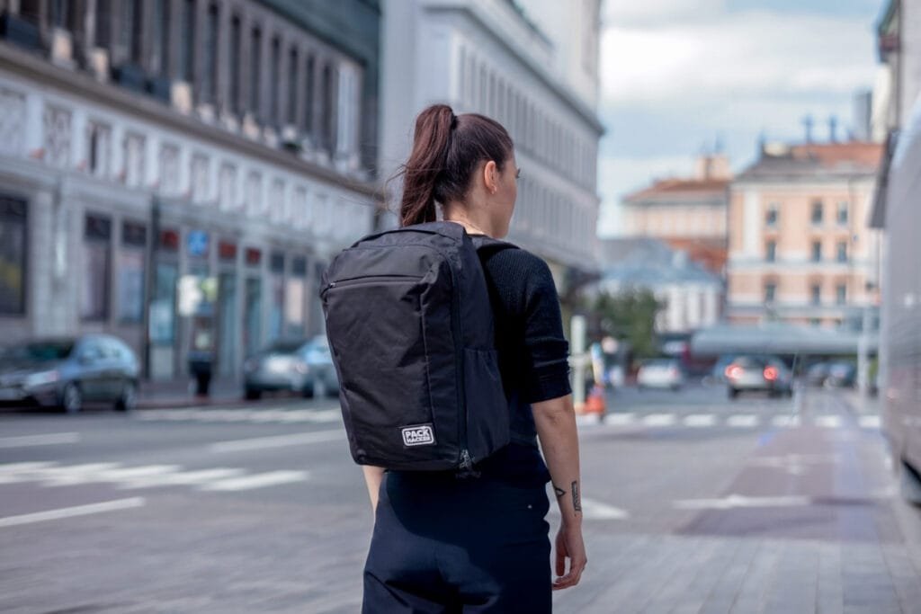 Best travel backpack Evergoods Civic Travel Bag CTB35 worn by person in bustling city setting.