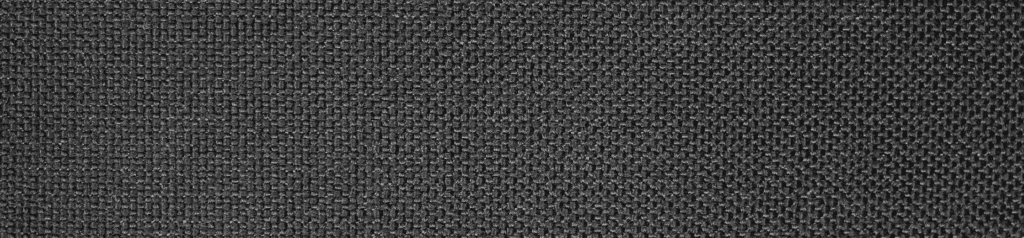 Best travel backpack closeup showcasing durable black woven fabric texture with sleek modern design.