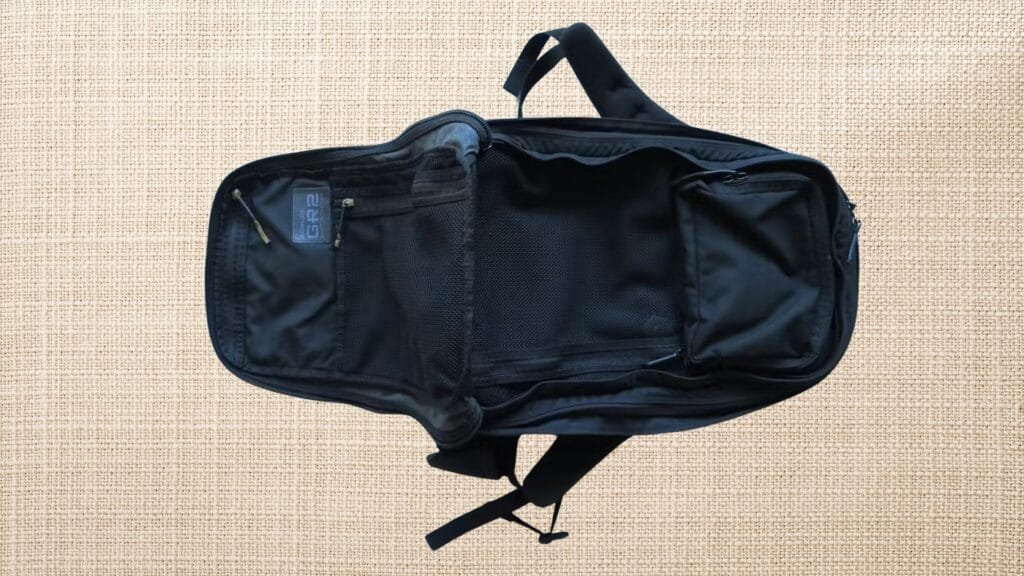 Goruck GR2 40L backpack interior view showcasing spacious compartments and sleek design against a beige backdrop.
