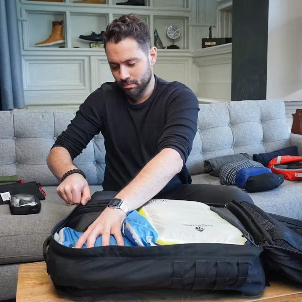 Goruck GR2 40L review showcasing efficient packing methods on a sleek, gray couch for travel preparation.