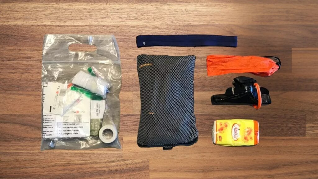 Goruck Gr2 40l review showcasing compact first-aid kit, utility pouch, straps, and gear clip.