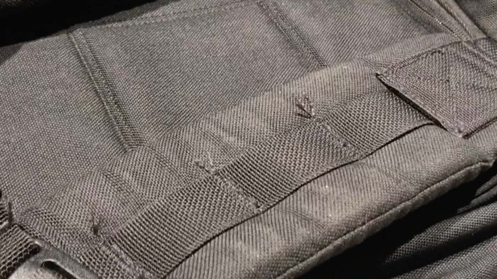 Frayed areas on the GORUCK GR2 tactical vest highlighting durable MOLLE webbing and resilient fabric.