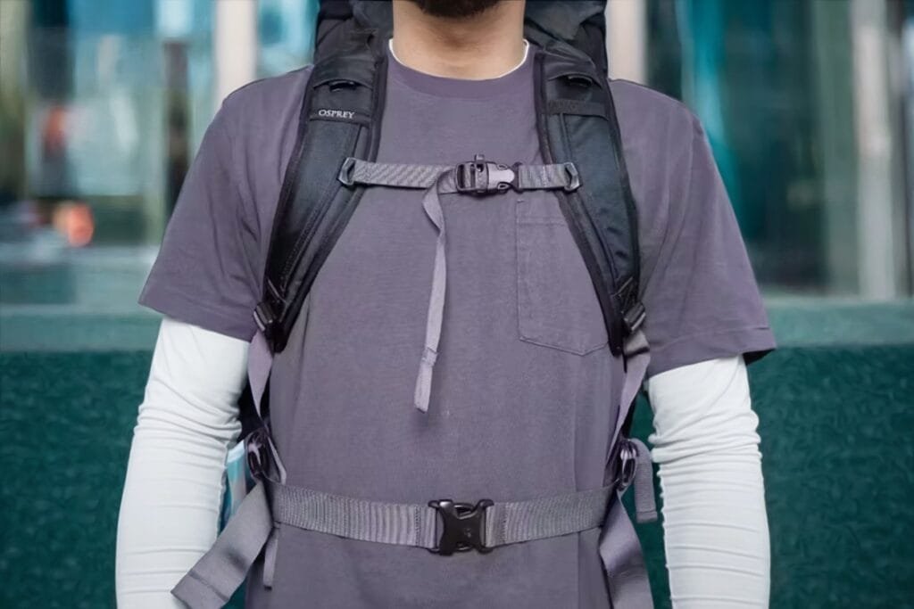 Osprey Farpoint 40 review: person wearing backpack with padded straps in urban setting.