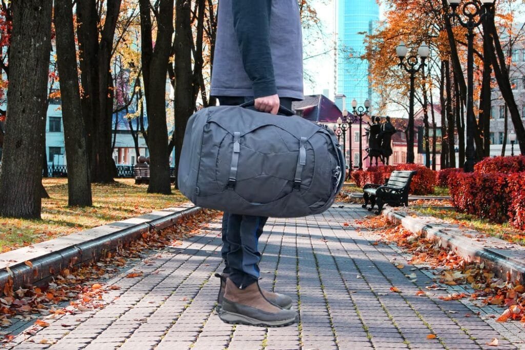 Osprey Farpoint 40 review showcasing durable travel bag on autumn park path with contrasting foliage.
