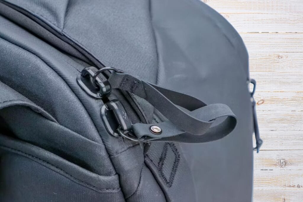 Peak Design Travel Backpack close-up featuring durable fabric, sleek black design, and functional zipper details.