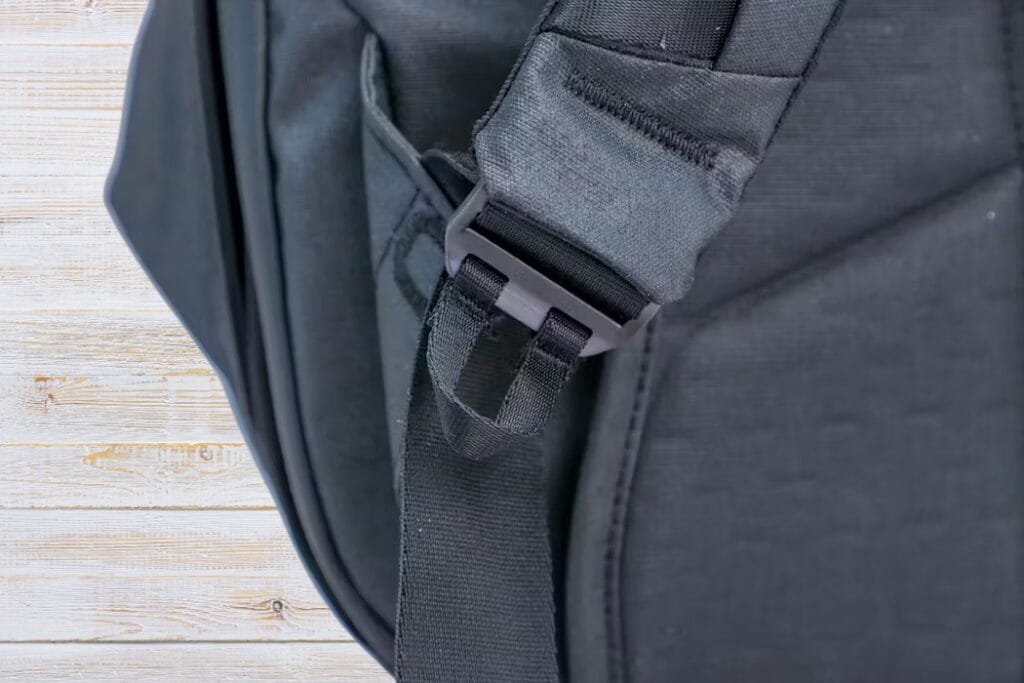 Peak Design Travel Backpack 30L close-up featuring durable black fabric, adjustable strap, and secure buckle.