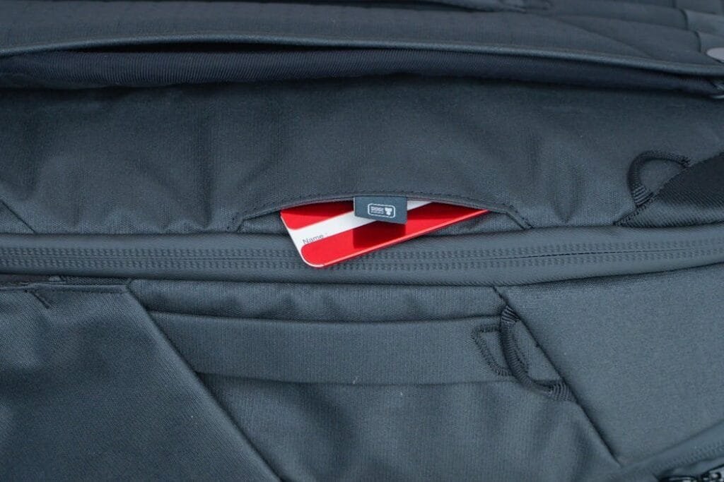 Peak Design Travel Backpack 30L interior view with zippered pocket and partially visible red-white card.
